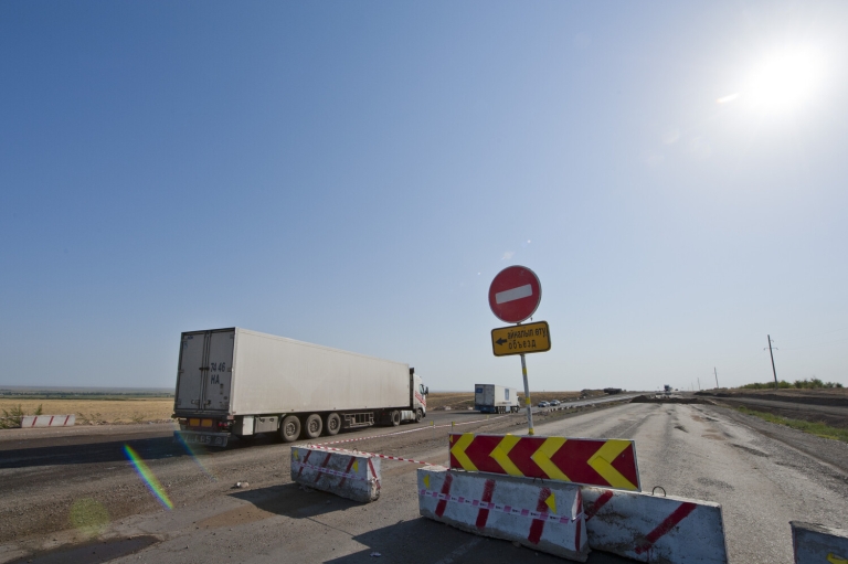 Traffic passing by the work area. 23 Aug. 2011. Zhambyl oblast. ADB section.