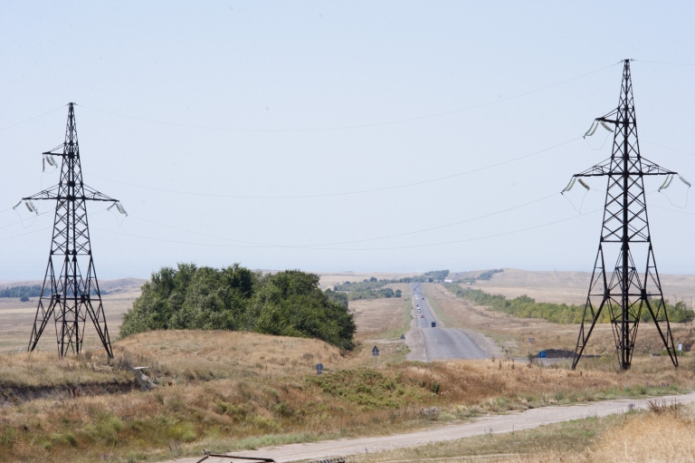 Power transmission line crosses the highway. 22 Aug.2011 Zhambyl oblast.